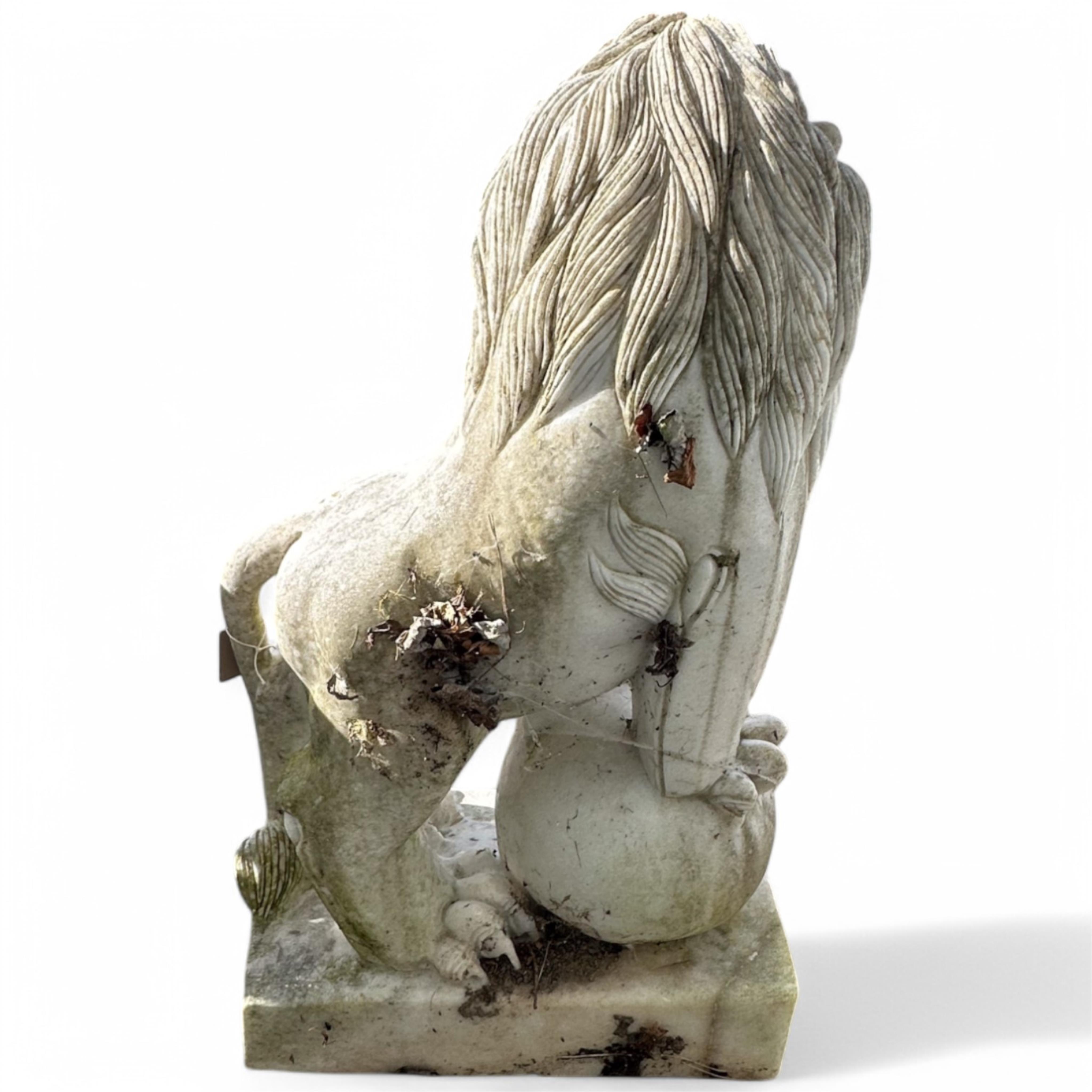 A pair of reconstituted white marble models of lions rampant